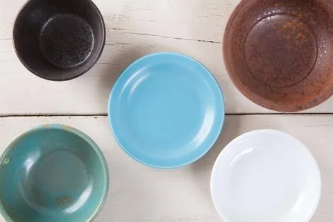 Top view of empty colorful plate put on white wood table. Stock Photos