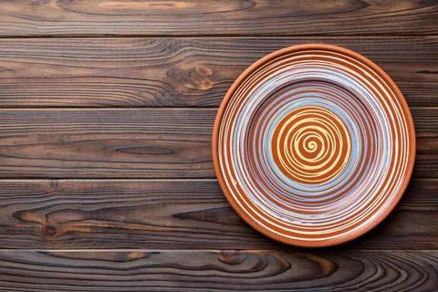 Top view of empty colorful plate on wooden background. Empty space for your d Stock Photos