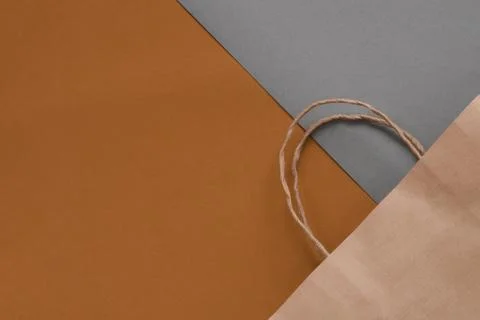 Top view of empty craft paper bag on a maroon background. Flat lay on maroon  Stock Photos