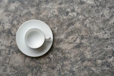 Top view of empty cup on saucer on gray background Stock Photos