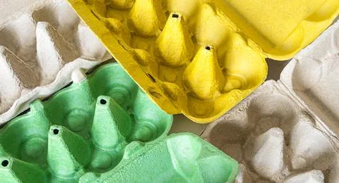 Top view of empty egg cartons. green, grey and yellow egg trays Stock Photos