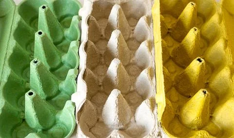 Top view of empty egg cartons. green, grey and yellow egg trays Stock Photos