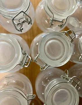 Top view of empty glass jars with metal clasps on wooden surface Stock Photos