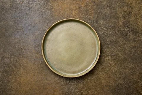 Top view empty green ceramic plate on brown rustic background Stock Photos