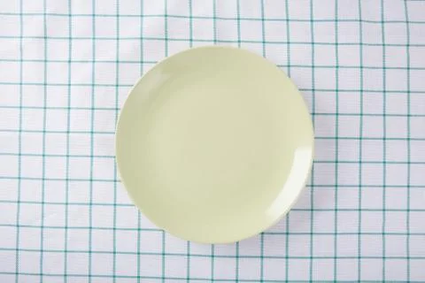 Top view of empty green plate put on cloth table with space for copy. Stock Photos