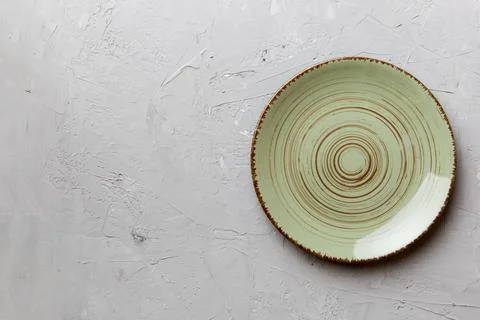 Top view of empty green plate on cement background. Empty space for your desi Stock Photos