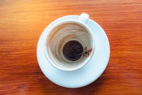 Top view of empty hot coffee cup after drink on wood table background. Stock Photos