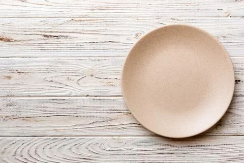 Top view of empty light plate on wooden background. Empty space for your desi Stock Photos