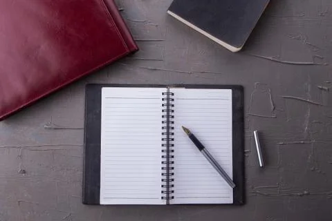 Top view of empty notebook with office equipments on desk Stock Photos