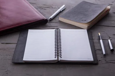 Top view of empty notebook with office equipments on desk Stock Photos