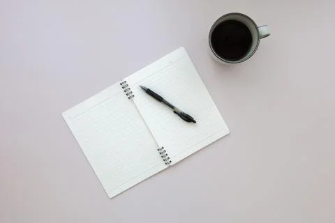 Top view of empty notebook with pen near cup of black coffee on pink background Stock Photos