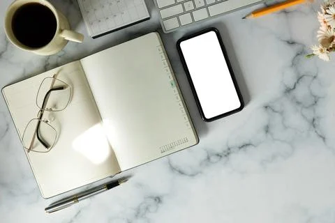 Top view empty notebook, smart phone, glasses, coffee cup and laptop computer Stock Photos