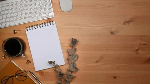 Top view empty notepad, coffee cup and notebook on wooden table. Stock Photos