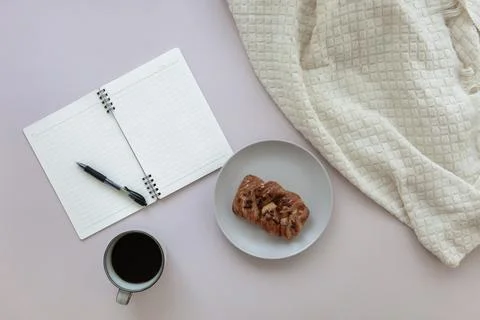 Top view of empty notepad with pen near cup of black coffee and pecan bun Stock Photos