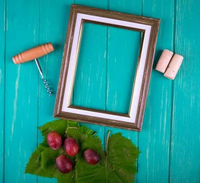 Top view of an empty picture frame with bottle screw , wine corks and sweet.. Stock Photos