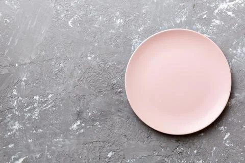 Top view of empty pink plate on cement background. Empty space for your desig Stock Photos