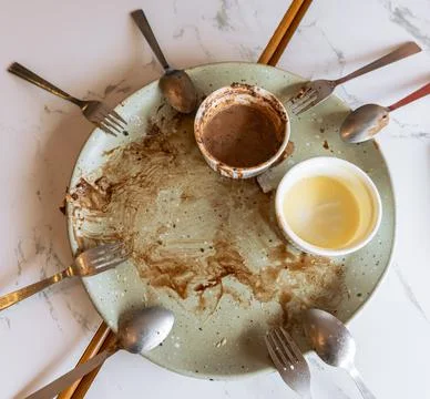 Top view of empty plate of dessert meal  with spoons and forks Stock Photos