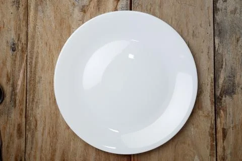 Top view empty plate on rustic wooden table Stock Photos