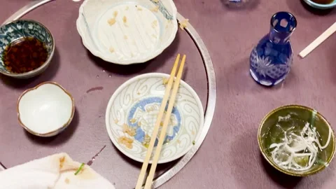 Top View of Empty Plates and Leftovers After Japanese Dining Experience Stock Footage 332830519