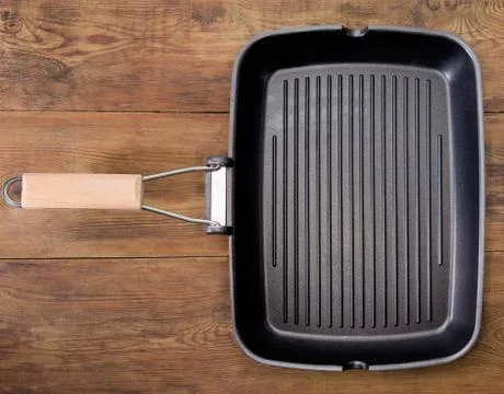 Top view of empty rectangular grill pan on rustic table Stock Photos
