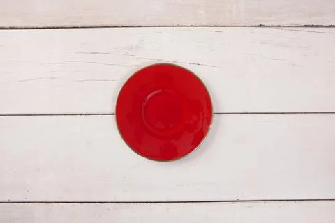 Top view of empty red plate put on white wood table with space for copy. Stock Photos