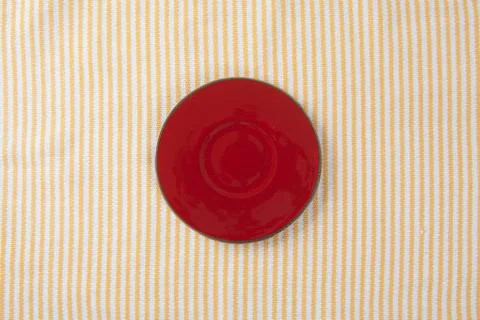 Top view of empty red plate put on cloth table with space for copy. Stock Photos