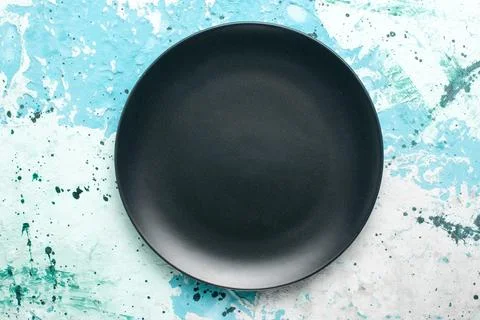 Top view empty round plate dark colored on blue background color plate kitc.. Stock Photos