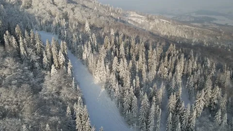 Top view of empty ski slopes. Drone flight above the snow-covered mountains Stock Footage 148244790