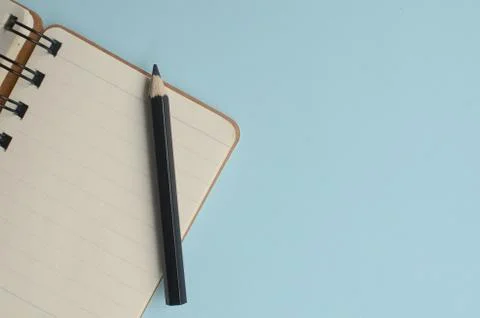 Top view empty space with colored pencils and notebooks on a blue background Stock Photos
