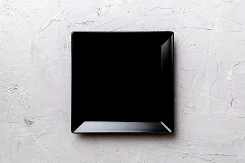 Top view of empty square plate on cement background. Empty space for your des Foto stock