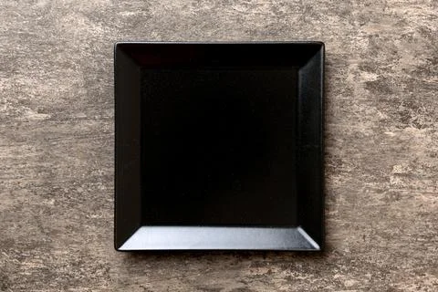 Top view of empty square plate on cement background. Empty space for your des Foto stock