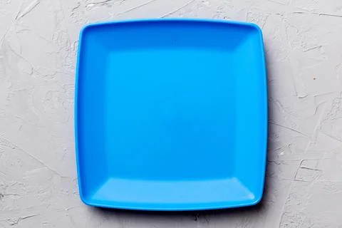 Top view of empty square plate on cement background. Empty space for your d.. Stock Photos
