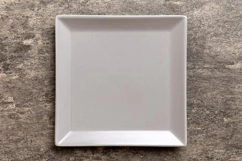 Top view of empty square plate on cement background. Empty space for your d.. Stock Photos