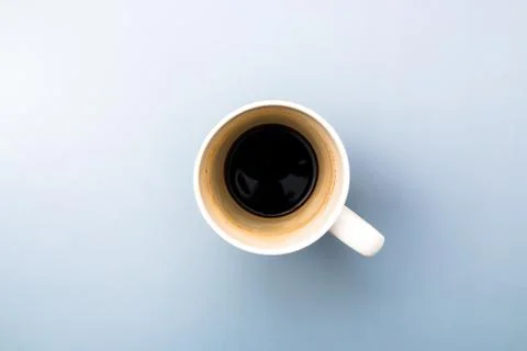 Top view of an empty white coffee mug on grey background Stock Photos