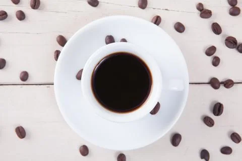 Top view of empty white cup coffee with black coffee and coffee seeds put on  Stock Photos