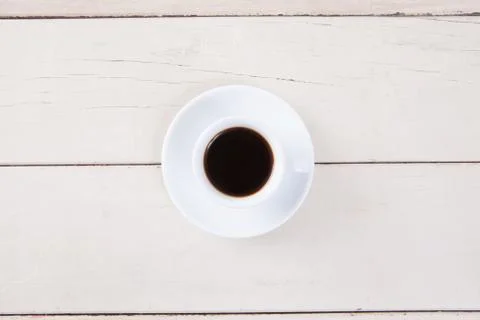 Top view of empty white cup coffee with black coffee put on white wood table  Stock Photos