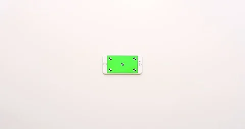 Top view on the empty white office table and white smartphone with green screen Stock Footage 85974827