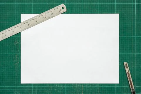 Top view of empty white paper A4 size on old grunge green dirty cutting mat Stock Photos