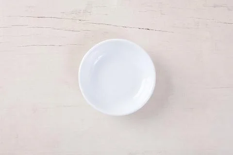 Top view of empty white plate put on white wood table with space for copy. Stock Photos