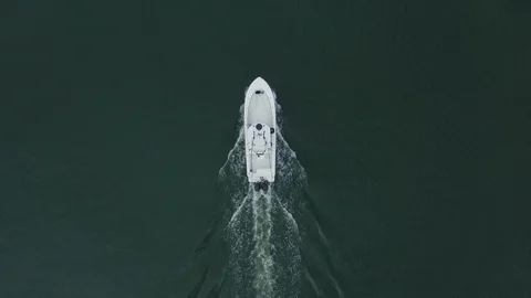 Top view of empty white ship sailing through a calm dark blue water Video stock 126610572