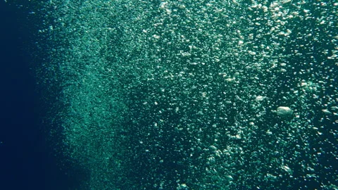 Top view of an endless stream of air bubbles rising upward from deep sea against Stock Footage 336508653