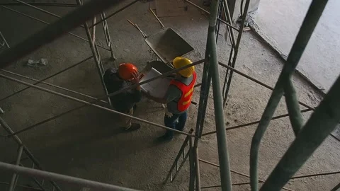 Top view of engineer discussing with foreman about project in construction site. Stock Footage 174085105