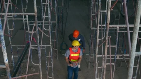 Top view of engineer discussing with foreman about project in construction site. Stock Footage 199923152