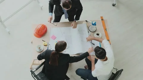 Top view. Engineer meeting Designers and brainstormers to create blueprints f Stock Footage 153657086