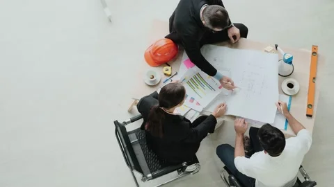 Top view. Engineer meeting Designers and brainstormers to create blueprints f Stock Footage 153658088