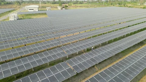 Top view of engineer worker is checking solar panel in solar farm. Stock Footage 238581596