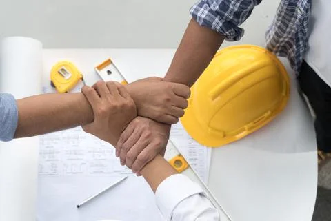 Top view engineering contractor joining hands with architect after finish mee Stock Photos