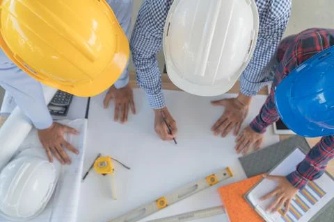 The top view of the engineering group is talking. Focus on safety helmet Stock Photos