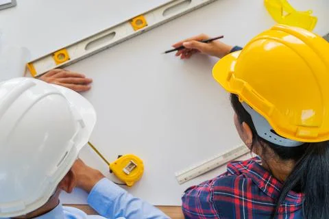 Top view of the engineers are planning. Focus on safety helmet Stock Photos