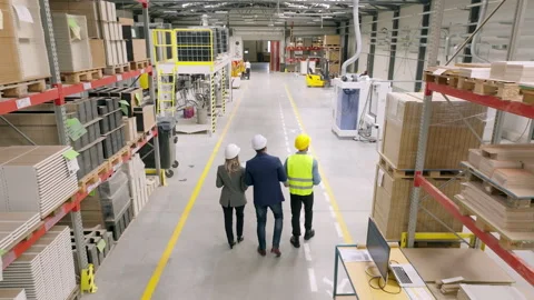 Top view of engineers consulting with director in modern industrial factory Stock Footage 262102979
